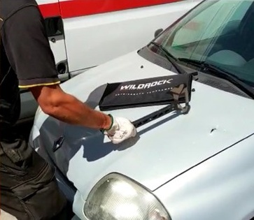 Firefighter testing the Strikeback on a vehicle bonnet