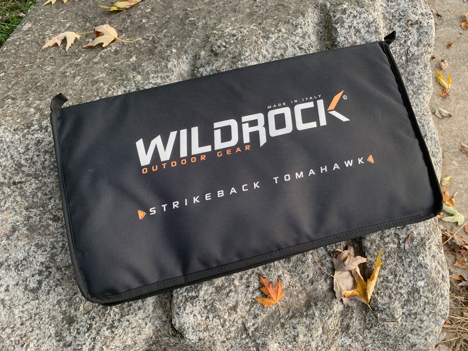 Closed padded WildRock Strikeback carry case photographed on stone