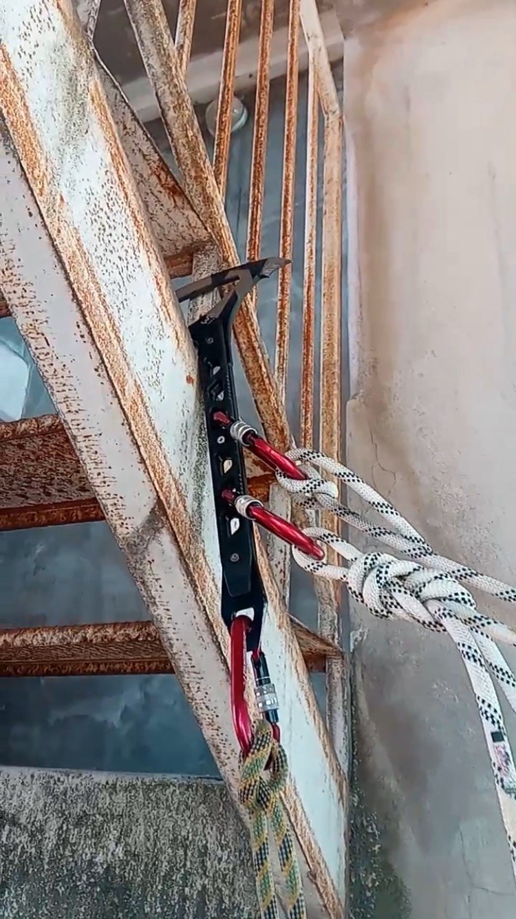 Strikeback positioned against a metal stair structure with ropes and carabiners attached