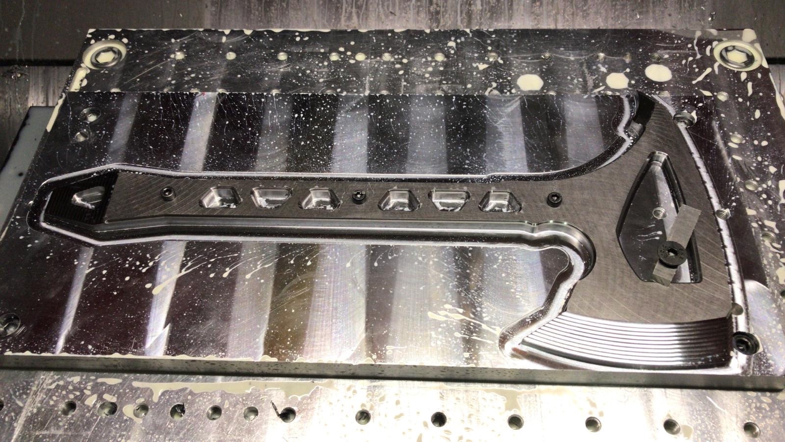 Original production photograph of the Strikeback steel body during precision CNC machining